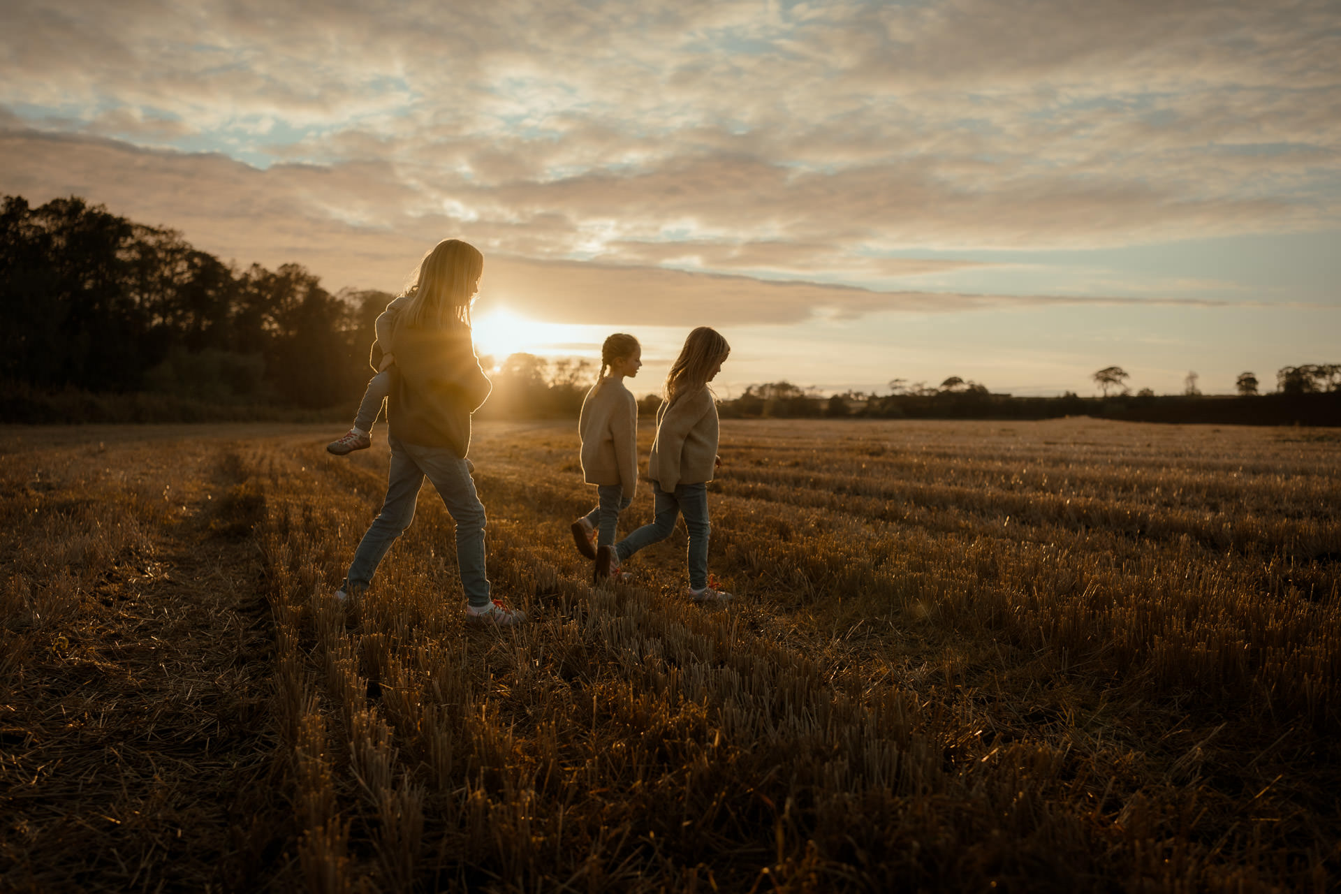 Ayrshire family photoshoot at sunset — children walking together during a natural outdoor session.