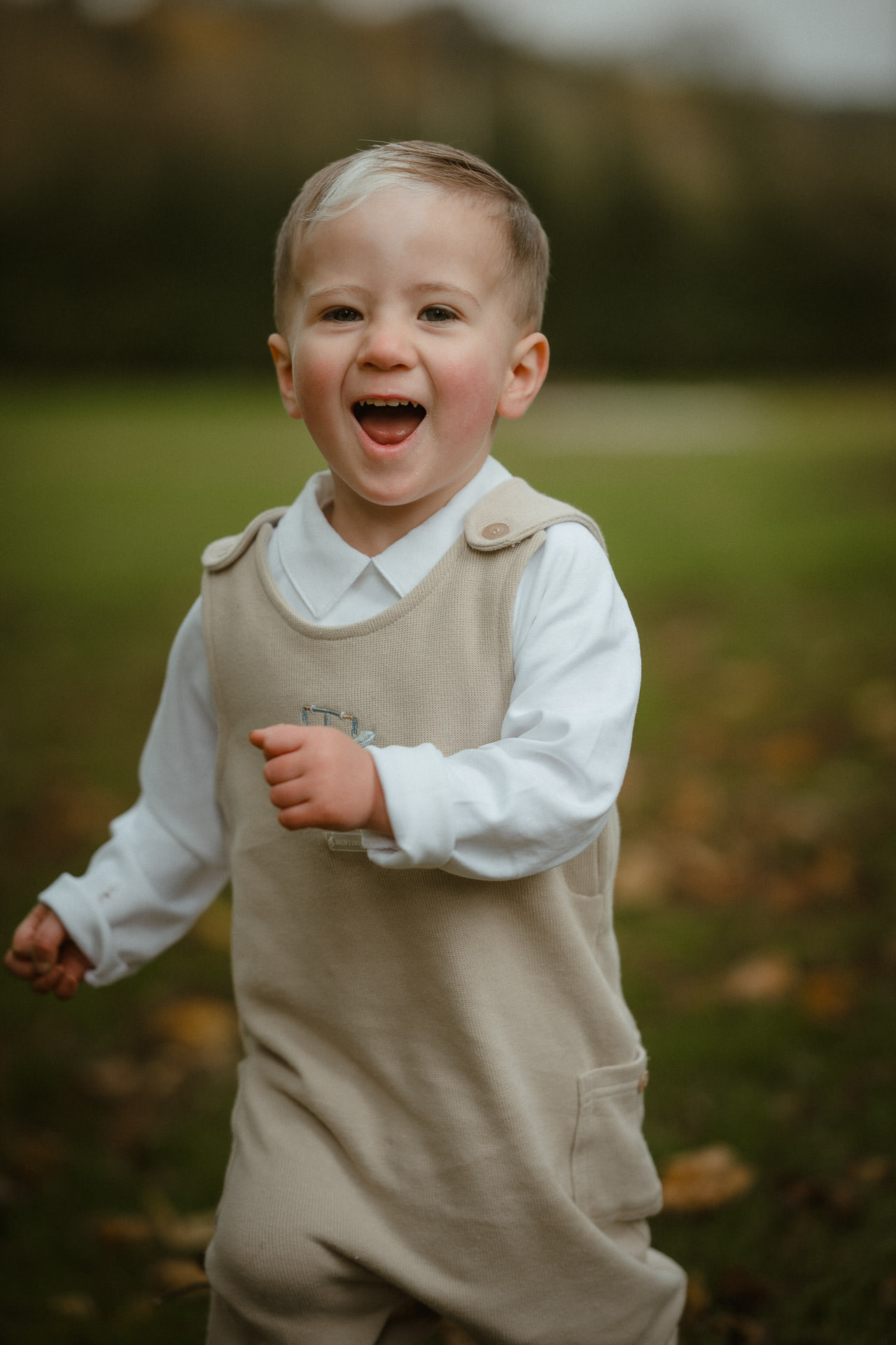 Brothers smiling together beside a large tree in Ayrshire.