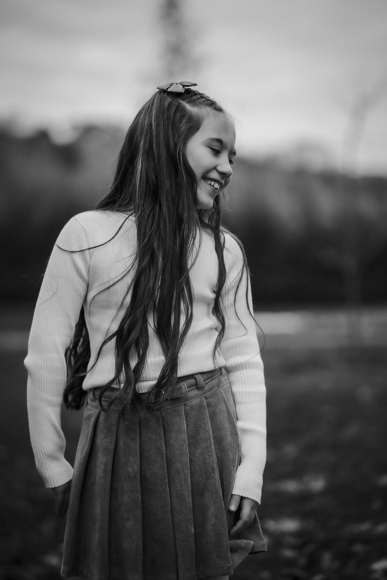 Four children walking through a harvested field at sunset in Ayrshire.