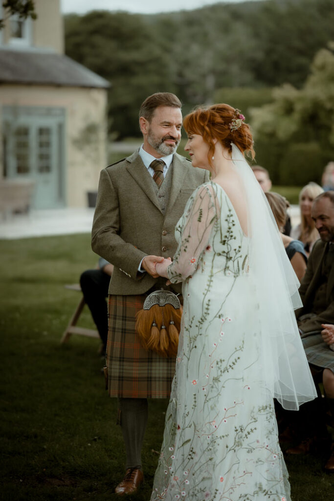 Relaxed Ayrshire wedding portrait of bride and groom outdoors.