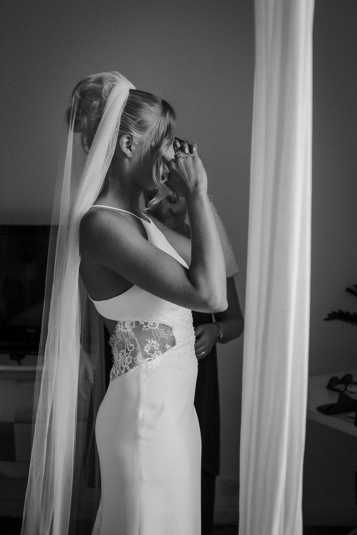 Bride standing by natural window light before her wedding in Glasgow