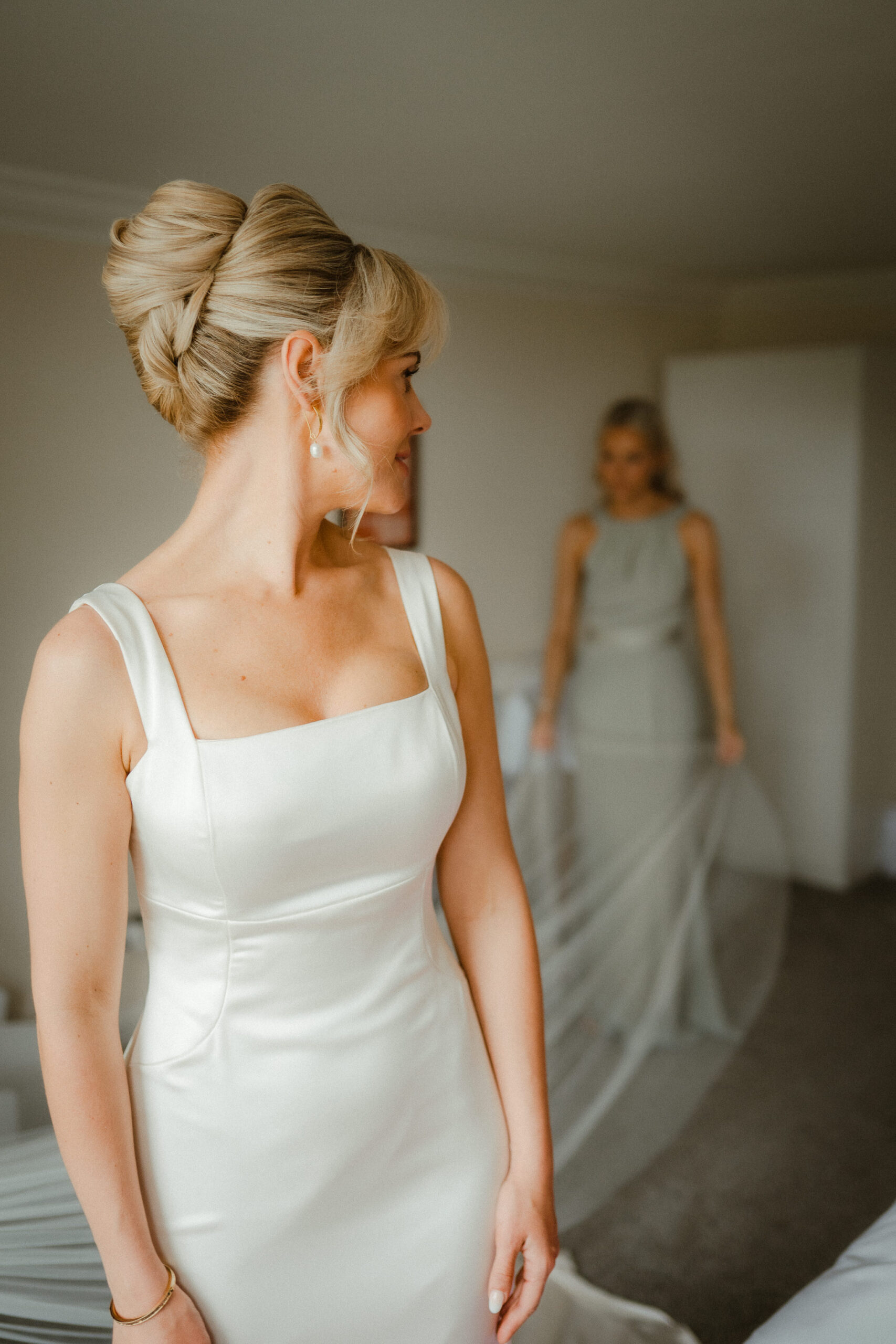 Bride looking back at her bridesmaid before the ceremony.