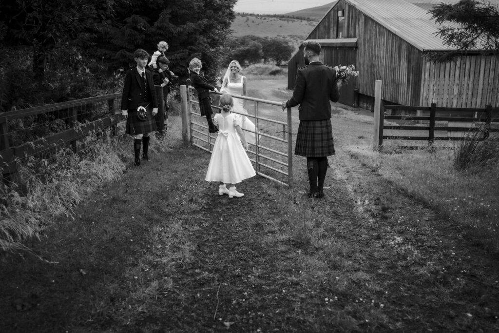 Bride and groom with children during relaxed wedding portraits at an Ayrshire countryside venue.