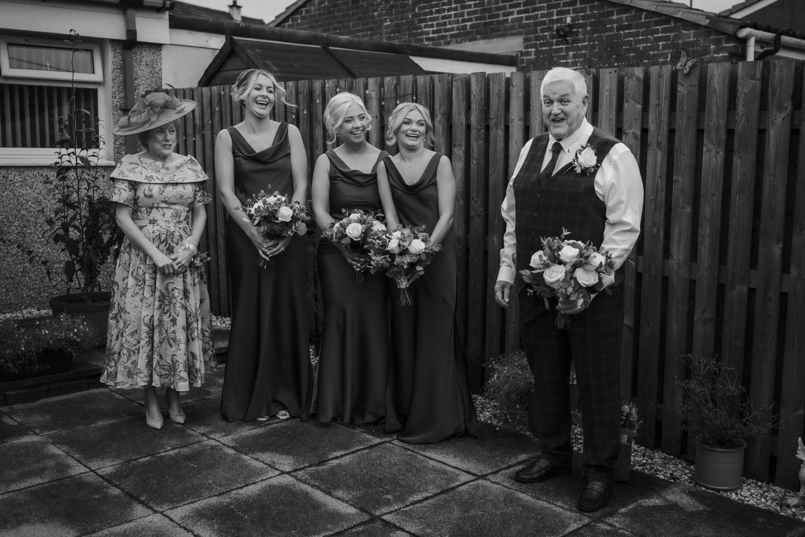 Bridesmaids and family laughing in the garden at home before the wedding in Fenwick